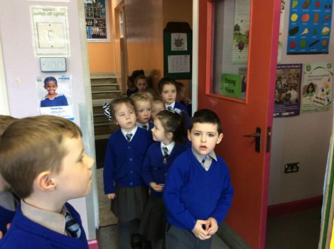 P1 & 2 pupils lining up to cast their votes